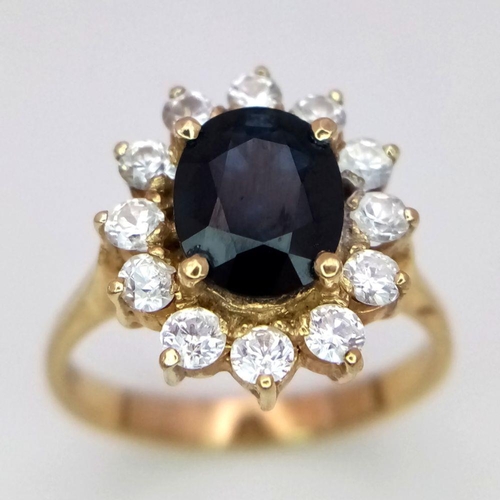 64 - A 14K Yellow Gold Sapphire and Diamond Ring. A beautiful 2ct oval sapphire with a brilliant round cu... 