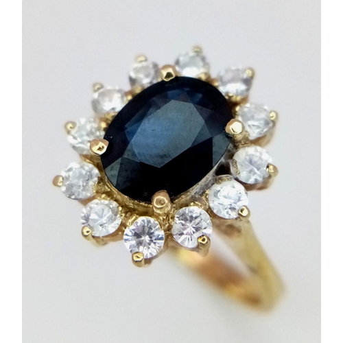 64 - A 14K Yellow Gold Sapphire and Diamond Ring. A beautiful 2ct oval sapphire with a brilliant round cu... 