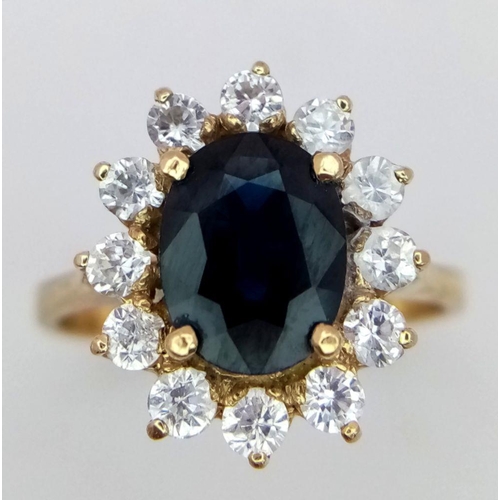 64 - A 14K Yellow Gold Sapphire and Diamond Ring. A beautiful 2ct oval sapphire with a brilliant round cu... 