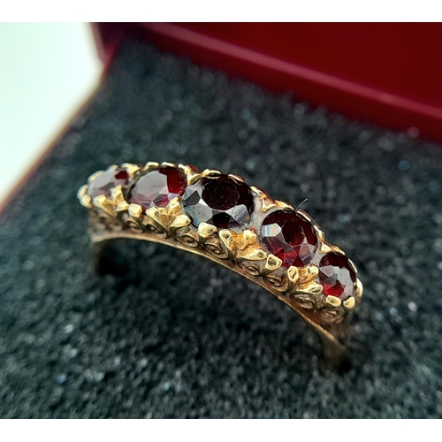 238 - Vintage 9 carat GOLD and GARNET RING. Consisting a sweep of 5 graduated Round Cut GARNETS  set to to... 