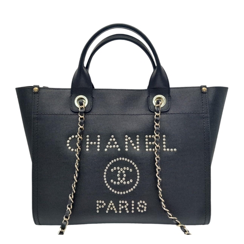 27 - A Chanel Deauville Tote Bag. Black leather exterior with gold tone hardware. Chanel, Paris silver to... 