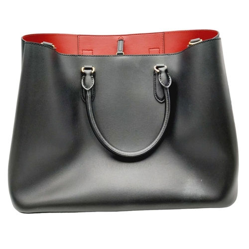 451 - A Ralph Lauren Black Leather Hand/Shoulder Bag. Gold tone hardware. Red leather interior with zipped... 