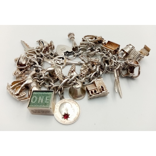 56 - Magnificent vintage SILVER CHARM BRACELET. Complete with Silver safety chain and Silver padlock fast... 
