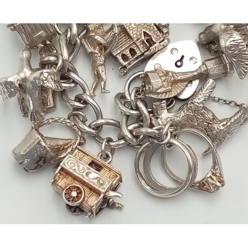 56 - Magnificent vintage SILVER CHARM BRACELET. Complete with Silver safety chain and Silver padlock fast... 