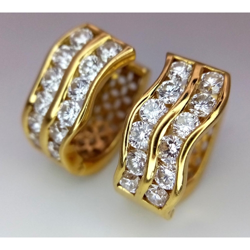 78 - A Pair of 18K Yellow Gold Horse-Shoe Diamond Earrings. Pierced decoration with each earring having t... 