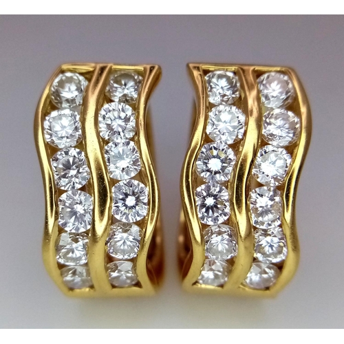 78 - A Pair of 18K Yellow Gold Horse-Shoe Diamond Earrings. Pierced decoration with each earring having t... 