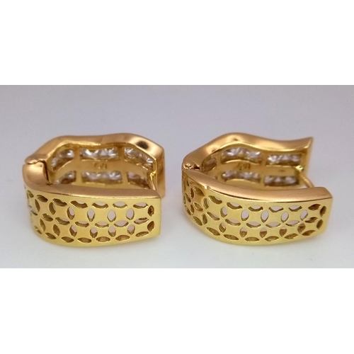 78 - A Pair of 18K Yellow Gold Horse-Shoe Diamond Earrings. Pierced decoration with each earring having t... 