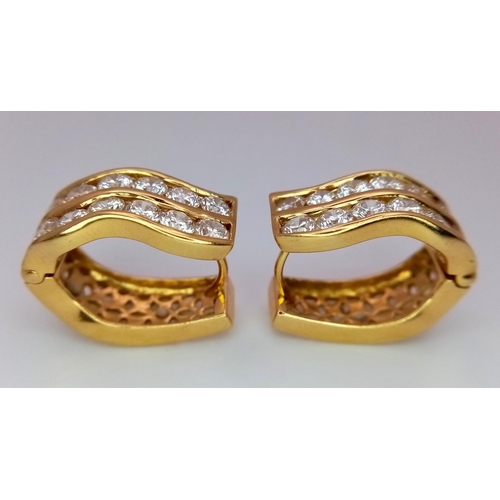 78 - A Pair of 18K Yellow Gold Horse-Shoe Diamond Earrings. Pierced decoration with each earring having t... 