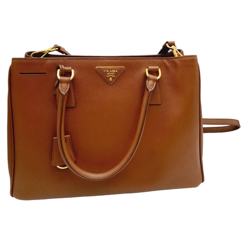 95 - A Prada Saffiano Lux Galleria Handbag. Textured brown exterior leather with gold tone hardware. Prad... 