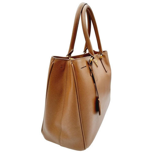 95 - A Prada Saffiano Lux Galleria Handbag. Textured brown exterior leather with gold tone hardware. Prad... 