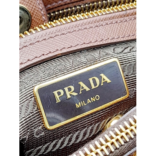 95 - A Prada Saffiano Lux Galleria Handbag. Textured brown exterior leather with gold tone hardware. Prad... 