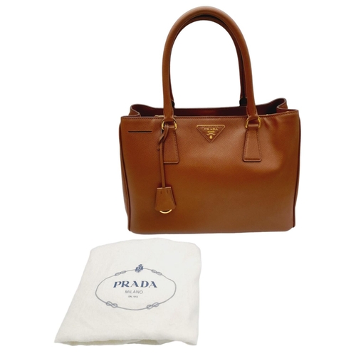 95 - A Prada Saffiano Lux Galleria Handbag. Textured brown exterior leather with gold tone hardware. Prad... 