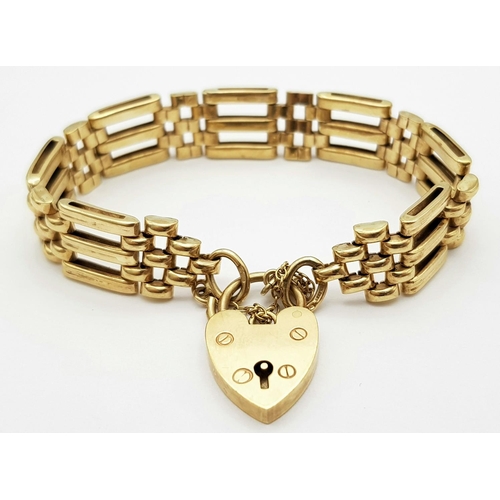 51 - A Well Constructed 9K Yellow Gold Gate Bracelet with Heart Clasp. 19g. 16cm