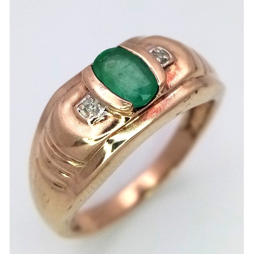 1652 - A 9K Yellow Gold Emerald and Diamond Ring. Oval cut emerald with a diamond either side. Size T 1/2. ... 