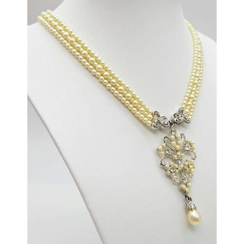 245 - A very elegant, vintage, three string faux pearl necklace with a sophisticated Art Nouveau pendant a... 