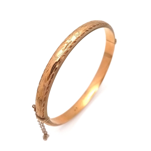 8 - A Vintage 9K Yellow Gold Bangle. Clip design with safety chain. 6cm inner diameter. 8.3g