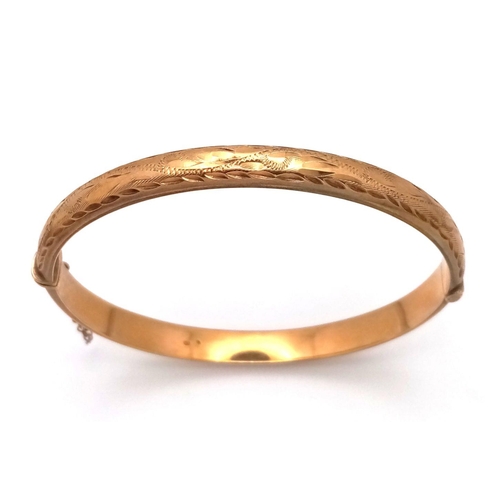 8 - A Vintage 9K Yellow Gold Bangle. Clip design with safety chain. 6cm inner diameter. 8.3g