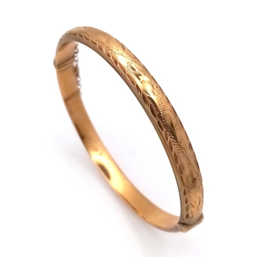 8 - A Vintage 9K Yellow Gold Bangle. Clip design with safety chain. 6cm inner diameter. 8.3g