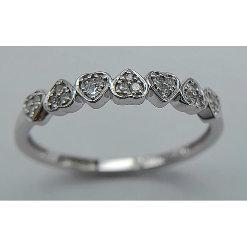 313 - A 9K WHITE GOLD DIAMOND MINI HEARTS BAND RING - 0.11CTW. 1.6G. SIZE P. REF: SC4060