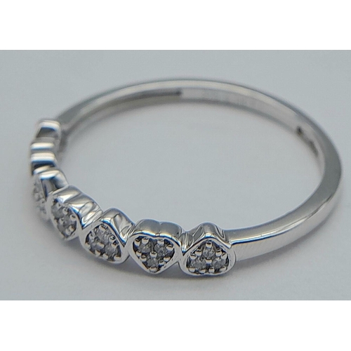 313 - A 9K WHITE GOLD DIAMOND MINI HEARTS BAND RING - 0.11CTW. 1.6G. SIZE P. REF: SC4060