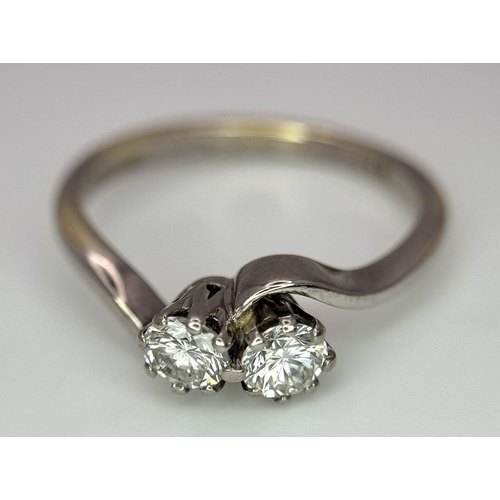 330 - AN 18K WHITE GOLD 2 STONE DIAMOND TWIST RING - 0.40CT. 2.9G. SIZE J. REF: PERS4006