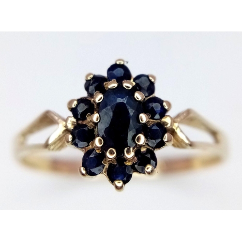 404 - A 9K YELLOW GOLD SAPPHIRE CLUSTER RING - 1.4G. SIZE N.
REF: SC4010