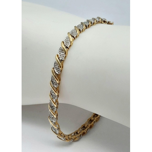 82 - A 9K YELLOW GOLD DIAMOND SET TENNIS BRACELET WITH SAFETY CATCH - 6.9G. 18CM. REF: SC4041