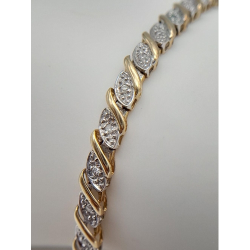 82 - A 9K YELLOW GOLD DIAMOND SET TENNIS BRACELET WITH SAFETY CATCH - 6.9G. 18CM. REF: SC4041