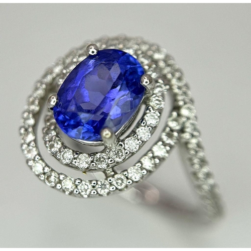 93 - AN 18K WHITE GOLD DIAMOND AND TANZANITE RING. 1.56CT OVAL TANZANITE AND 0.35CTW DIAMONDS. 4.4G. SIZE... 