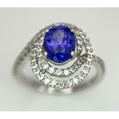 93 - AN 18K WHITE GOLD DIAMOND AND TANZANITE RING. 1.56CT OVAL TANZANITE AND 0.35CTW DIAMONDS. 4.4G. SIZE... 