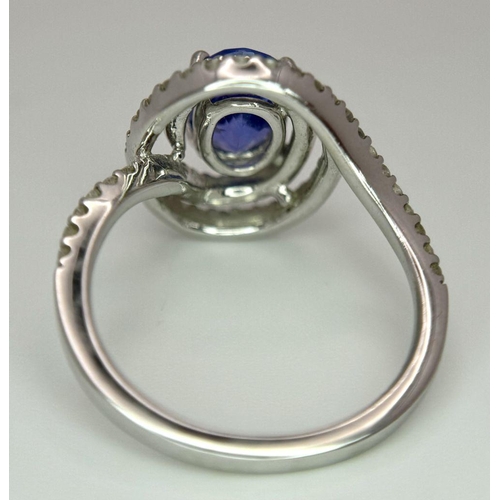 93 - AN 18K WHITE GOLD DIAMOND AND TANZANITE RING. 1.56CT OVAL TANZANITE AND 0.35CTW DIAMONDS. 4.4G. SIZE... 