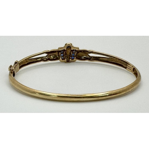 151 - A 9K YELLOW GOLD ( TESTED ) DIAMOND AND SAPPHIRE BANGLE 9.5G WITH SAFETY CATCH. 6CM INNER DIAMETER. ... 