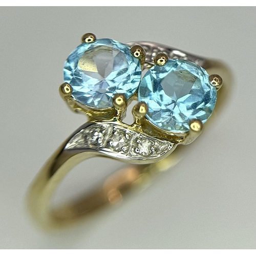 388 - An Excellent Condition Hallmarked 2000 9 Carat Gold Blue Topaz and Diamond Crossover Ring Size K. Se... 