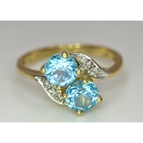 388 - An Excellent Condition Hallmarked 2000 9 Carat Gold Blue Topaz and Diamond Crossover Ring Size K. Se... 