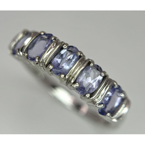 444 - An Excellent Condition Hallmarked 2006, 9 Carat Gold and five stone Tanzanite Ring Size N. Set with ... 