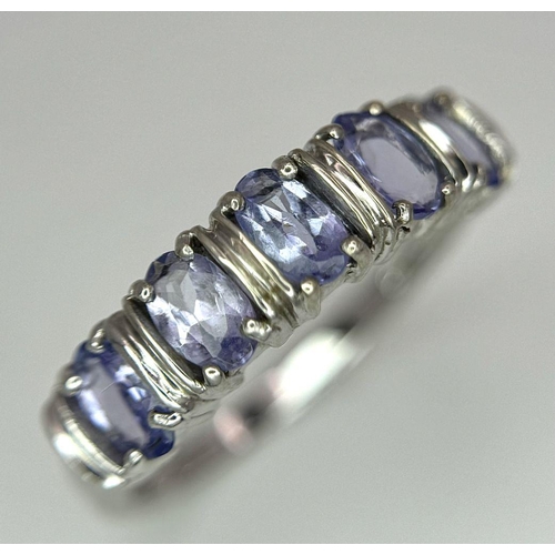 444 - An Excellent Condition Hallmarked 2006, 9 Carat Gold and five stone Tanzanite Ring Size N. Set with ... 