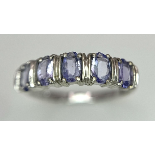 444 - An Excellent Condition Hallmarked 2006, 9 Carat Gold and five stone Tanzanite Ring Size N. Set with ... 