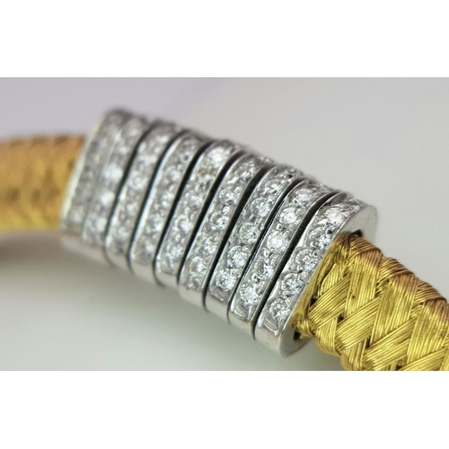 61 - AN 18K YELLOW GOLD DIAMOND SET BRACELET WITH A SERPENTINE WEAVED EFFECT - 0.60CTW. 23.4G. 
5.5CM INN... 