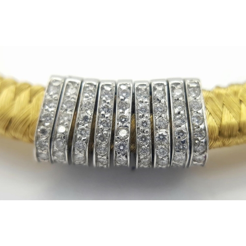 61 - AN 18K YELLOW GOLD DIAMOND SET BRACELET WITH A SERPENTINE WEAVED EFFECT - 0.60CTW. 23.4G. 
5.5CM INN... 