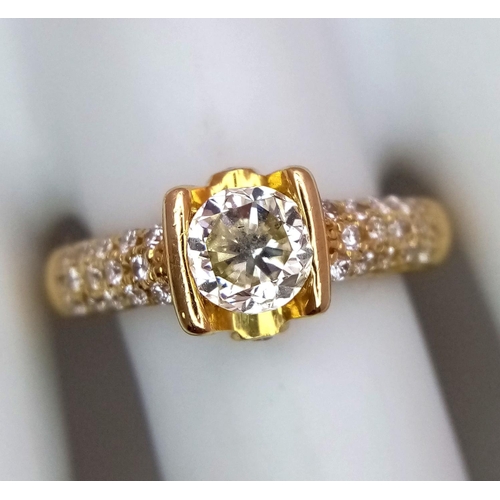 184 - An 18K Yellow Gold and Diamond Gents Dress Ring. A 1.044ct brilliant round cut centre diamond is acc... 