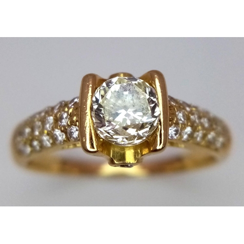 184 - An 18K Yellow Gold and Diamond Gents Dress Ring. A 1.044ct brilliant round cut centre diamond is acc... 