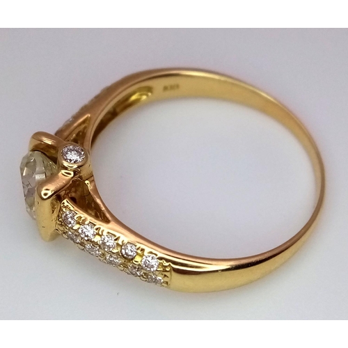 184 - An 18K Yellow Gold and Diamond Gents Dress Ring. A 1.044ct brilliant round cut centre diamond is acc... 