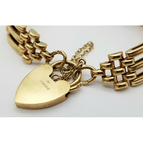 269 - A Well Constructed 9K Yellow Gold Gate Bracelet with Heart Clasp. 19g. 16cm