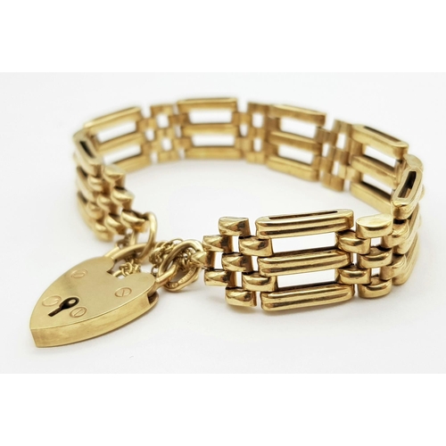 269 - A Well Constructed 9K Yellow Gold Gate Bracelet with Heart Clasp. 19g. 16cm