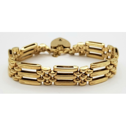 269 - A Well Constructed 9K Yellow Gold Gate Bracelet with Heart Clasp. 19g. 16cm