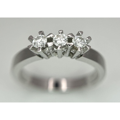 311 - A 18K White Gold Diamond 3 Stone Ring, 3.9g total weight, 0.21ct diamond, size M 1/2.

ref: 158I