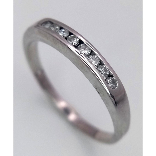 318 - A 18K White Gold Diamond 1/2 Eternity Ring, 2.7g total weight, 0.15ct diamond, size Q 1/2.

ref: 746... 