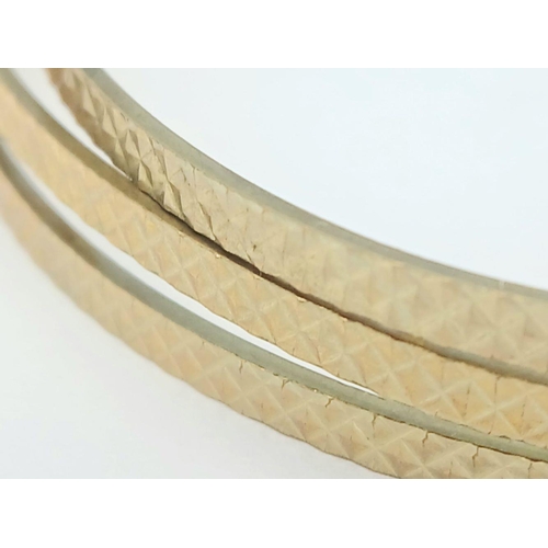 100 - A MATCHING SET OF 3 PATTERNED BANGLES IN 9K GOLD .   12.7gms