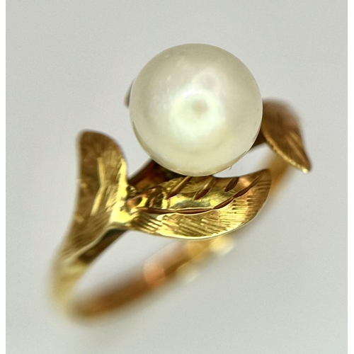 135 - AN 18K GOLD RING WITH A CENTRAL PEARL NESTLING IN BETWEEN FOLIAGE .  2gms    size J/K