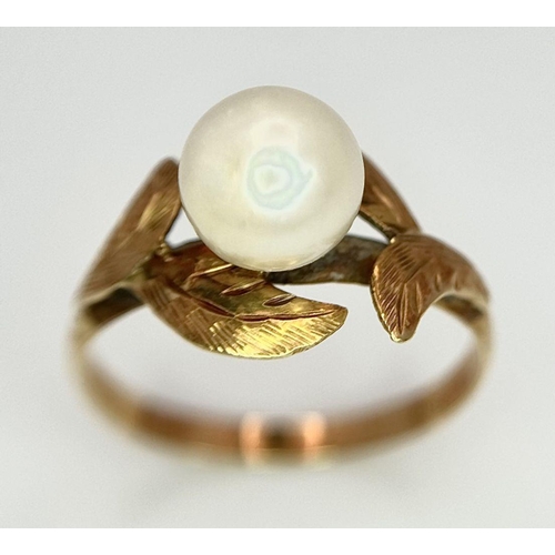 135 - AN 18K GOLD RING WITH A CENTRAL PEARL NESTLING IN BETWEEN FOLIAGE .  2gms    size J/K